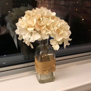 Faux flowers in glass vase